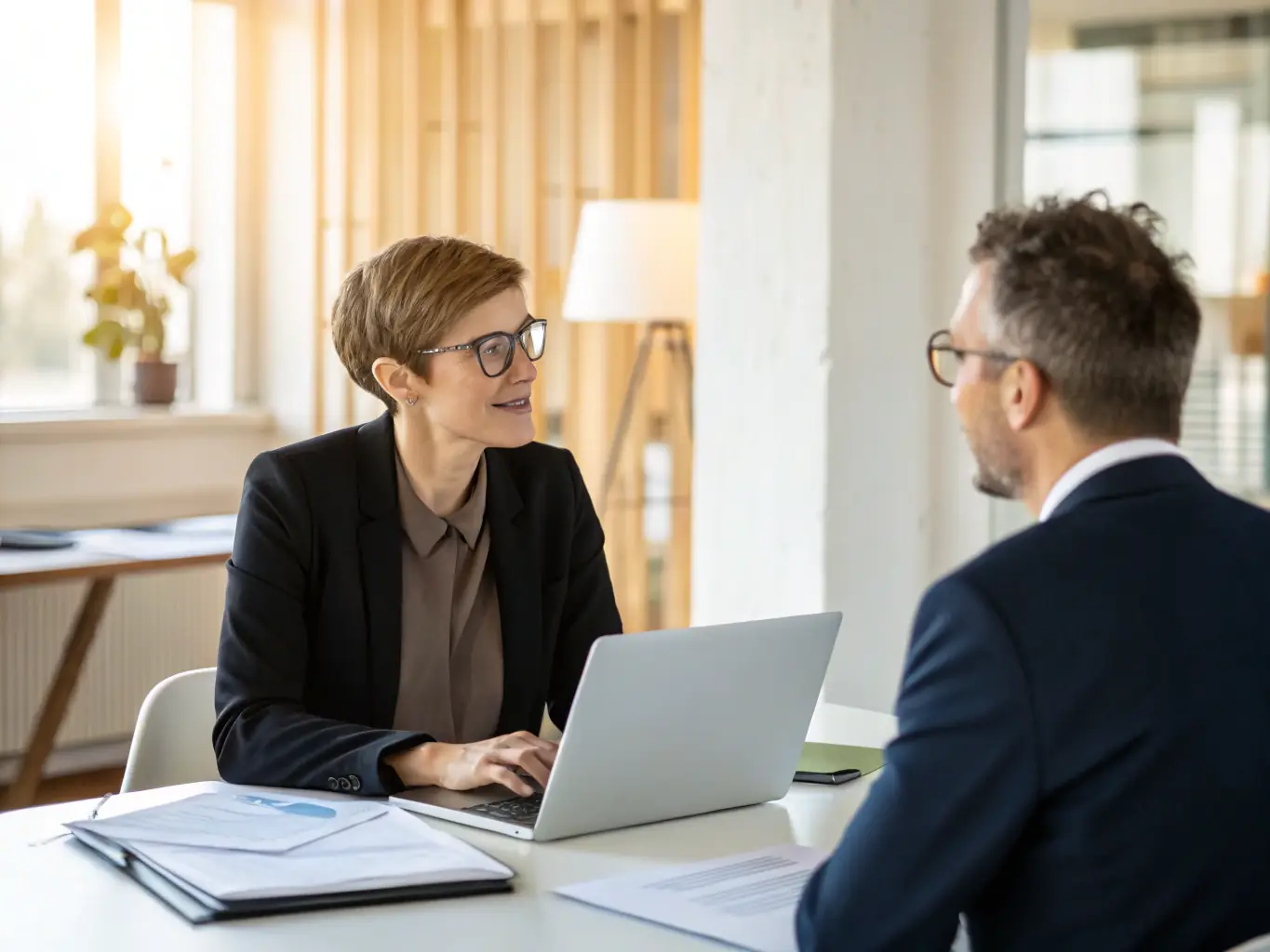A business coach conducting a one-on-one session with a client, focusing on personal development and leadership skills, in a relaxed and supportive environment.
